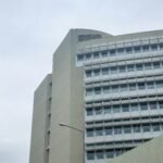 a tall building with a clock on the front of it