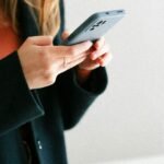 a woman holding a cell phone in her hands